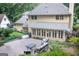 An eye-level exterior view of the back of the house, showing a cozy patio and a beautiful yard with lush landscaping at 148 Lakeside Dr, Peachtree City, GA 30269