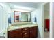 Bathroom with a double sink vanity featuring granite countertops and dark wood cabinets at 148 Lakeside Dr, Peachtree City, GA 30269