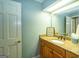 Bathroom with granite countertop, framed mirror, and decorative light fixture at 148 Lakeside Dr, Peachtree City, GA 30269
