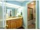 Well-lit bathroom featuring a vanity with granite countertops and wooden cabinets at 148 Lakeside Dr, Peachtree City, GA 30269