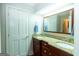 Bathroom with a double sink vanity featuring granite countertops and dark wood cabinets at 148 Lakeside Dr, Peachtree City, GA 30269