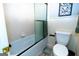 Bright bathroom featuring a shower and tub with a frosted glass door at 148 Lakeside Dr, Peachtree City, GA 30269