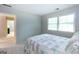 Serene bedroom with natural light streaming through a window and hallway view at 148 Lakeside Dr, Peachtree City, GA 30269