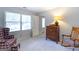 Cozy bedroom featuring a wooden dresser, rocking chair, and ample natural light at 148 Lakeside Dr, Peachtree City, GA 30269