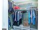 Open closet with clothes, shelves, and a box on the floor at 148 Lakeside Dr, Peachtree City, GA 30269
