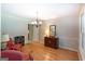 Formal dining room with hardwood floors, chandelier, and traditional furniture arrangement for entertaining at 148 Lakeside Dr, Peachtree City, GA 30269