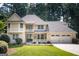 Charming two-story home featuring a spacious front porch, three-car garage, and beautifully landscaped front yard at 148 Lakeside Dr, Peachtree City, GA 30269