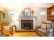 Close-up of a living room fireplace with hardwood floors, classic furnishings, and a decorative mantel at 148 Lakeside Dr, Peachtree City, GA 30269