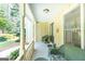 Welcoming covered front porch with wicker furniture and a glimpse of the beautifully landscaped yard at 148 Lakeside Dr, Peachtree City, GA 30269