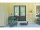 Covered front porch features a comfortable seating area with a welcome sign at 148 Lakeside Dr, Peachtree City, GA 30269