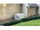 Exterior shot of home's HVAC unit set amongst manicured landscaping at 148 Lakeside Dr, Peachtree City, GA 30269