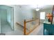 Hallway with wood railing leading to the upper level at 148 Lakeside Dr, Peachtree City, GA 30269