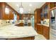 A kitchen features granite countertops, stainless steel appliances, wood cabinets and floors, and recessed lighting at 148 Lakeside Dr, Peachtree City, GA 30269