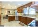 Spacious kitchen featuring granite counters, stainless steel appliances, and tile backsplash at 148 Lakeside Dr, Peachtree City, GA 30269