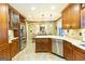 A kitchen is furnished with wood cabinets, granite counters, stainless steel appliances, and pendant lighting at 148 Lakeside Dr, Peachtree City, GA 30269