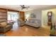 Open living room featuring hardwood floors, built-in shelves, comfortable sofas, and natural light at 148 Lakeside Dr, Peachtree City, GA 30269