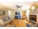 Spacious living room with hardwood floors, fireplace, a large TV, and comfortable seating at 148 Lakeside Dr, Peachtree City, GA 30269