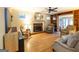 Inviting living room with hardwood floors, brick fireplace, a ceiling fan, and a cozy seating area at 148 Lakeside Dr, Peachtree City, GA 30269