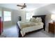 Spacious bedroom features a ceiling fan, neutral walls, and an inviting king-size bed with a decorative quilt at 148 Lakeside Dr, Peachtree City, GA 30269