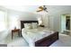 Cozy bedroom features a king-size bed, ceiling fan, and a walk-in closet with an open door at 148 Lakeside Dr, Peachtree City, GA 30269