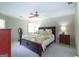 Spacious bedroom features a ceiling fan, neutral walls, and an inviting king-size bed with a decorative quilt at 148 Lakeside Dr, Peachtree City, GA 30269