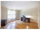 Bright home office features hardwood flooring and a large window that lets in abundant natural light at 148 Lakeside Dr, Peachtree City, GA 30269