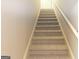 A carpeted staircase leads upward, featuring neutral walls and white trim at 148 Lakeside Dr, Peachtree City, GA 30269