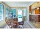 Sunroom with tile floors, dining table, and view of the backyard at 148 Lakeside Dr, Peachtree City, GA 30269