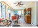 Sunroom with tile floors, ceiling fan, many windows, and seating at 148 Lakeside Dr, Peachtree City, GA 30269