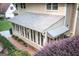 Rear exterior view of the sunroom, with large windows offering plenty of natural light and access to the garden at 148 Lakeside Dr, Peachtree City, GA 30269