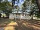 This home features a spacious, tree-shaded backyard with deck, offering a peaceful outdoor retreat at 10103 Allen Sw Dr, Covington, GA 30014