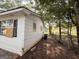 Exterior view of the rear of the house with fenced yard and trees at 10103 Allen Sw Dr, Covington, GA 30014