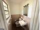This is a small bathroom featuring a sink, toilet, and mirror at 10103 Allen Sw Dr, Covington, GA 30014