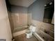 Compact bathroom with a tub, toilet, sink and neutral tile at 10103 Allen Sw Dr, Covington, GA 30014