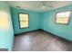 Bedroom showcasing fresh paint, two windows, and wood-look flooring at 10103 Allen Sw Dr, Covington, GA 30014