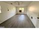 Spacious bedroom with damaged flooring, two windows, and a ceiling fan awaits your personal touch at 10103 Allen Sw Dr, Covington, GA 30014