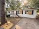 View of home's painted brick exterior, porch with flower bed and long driveway at 10103 Allen Sw Dr, Covington, GA 30014