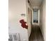 Hallway with white walls, damaged flooring, and access to other rooms needing renovation at 10103 Allen Sw Dr, Covington, GA 30014