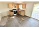 A traditional kitchen with wood cabinets and dated appliances and damaged flooring needs renovation at 10103 Allen Sw Dr, Covington, GA 30014