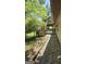 A view of the two-level deck in the backyard, with lush greenery all around at 1448 Se Hillside Place, Conyers, GA 30094