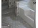 Bathroom showcasing bathtub and white hexagonal tile flooring at 1448 Se Hillside Place, Conyers, GA 30094