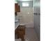 Bathroom with shower-tub combo, patterned tile floor, and floral wallpaper at 1448 Se Hillside Place, Conyers, GA 30094