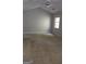 Bedroom featuring gray walls, carpet, a ceiling fan, and a window at 1448 Se Hillside Place, Conyers, GA 30094