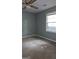Bedroom featuring green walls, carpet, a ceiling fan, and a window at 1448 Se Hillside Place, Conyers, GA 30094