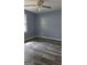 Bedroom featuring gray walls, wood-look floors, a ceiling fan, and a window at 1448 Se Hillside Place, Conyers, GA 30094