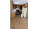 Kitchen featuring light colored cabinets, laminate flooring and appliances at 1448 Se Hillside Place, Conyers, GA 30094