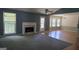Cozy living room with a fireplace and a large window for natural light at 1448 Se Hillside Place, Conyers, GA 30094
