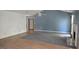 Open-concept living room with wood-style floors, fireplace and neutral paint at 1448 Se Hillside Place, Conyers, GA 30094