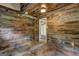 Finished basement features rustic wood walls and ceiling, with a glimpse into an adjoining room at 3681 Chestnut Lake Ct, Jonesboro, GA 30236