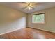 Bedroom featuring hardwood floors, ceiling fan, and window with natural light at 3681 Chestnut Lake Ct, Jonesboro, GA 30236